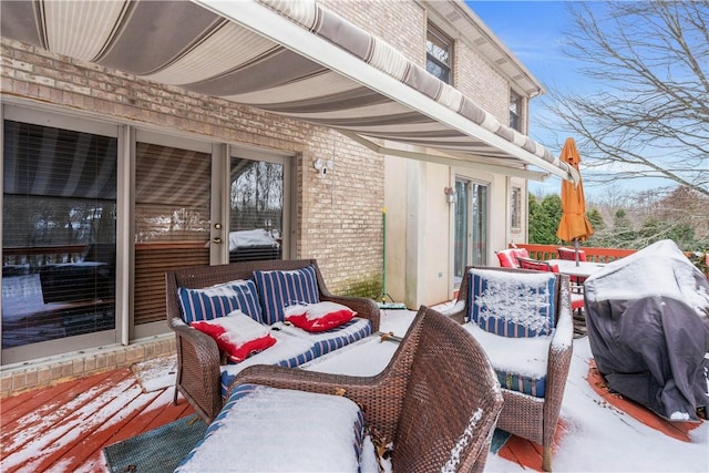 snow covered patio featuring grilling area