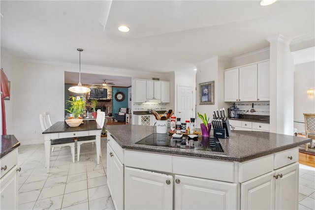 kitchen featuring ceiling fan, crown molding, black electric cooktop, decorative backsplash, and white cabinets