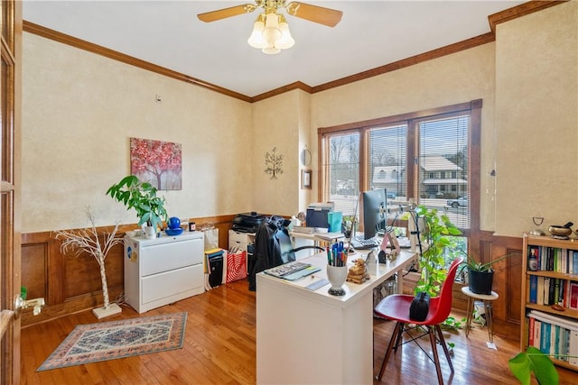 office space featuring ceiling fan, ornamental molding, and light wood-type flooring