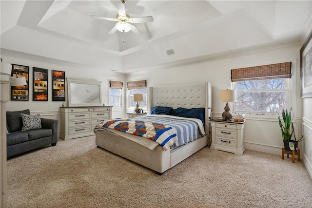 bedroom with light colored carpet, multiple windows, and ceiling fan