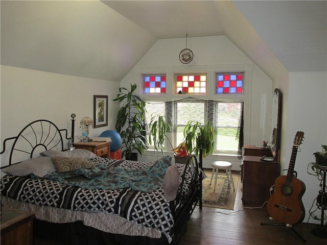 bedroom with hardwood / wood-style flooring and lofted ceiling