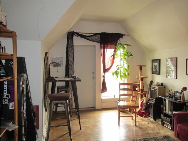 sitting room featuring light wood-type flooring and vaulted ceiling