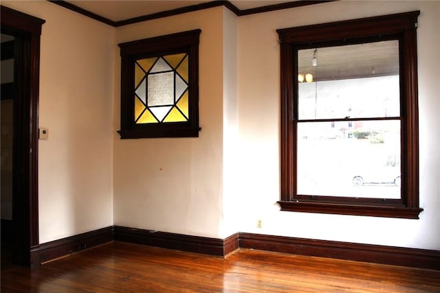 unfurnished room with wood-type flooring and ornamental molding