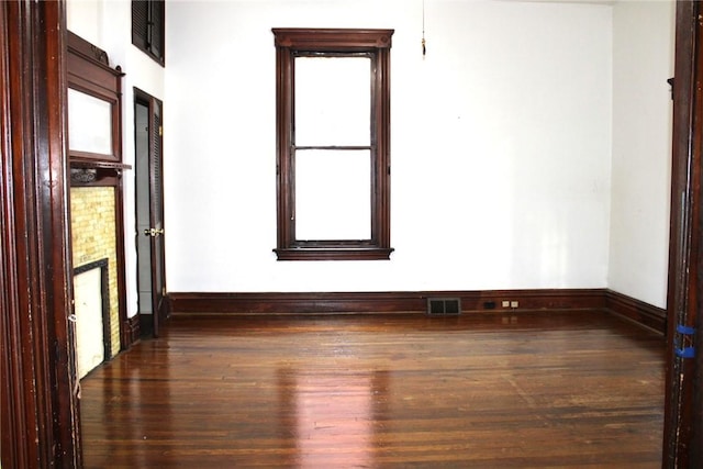 empty room featuring dark wood-type flooring