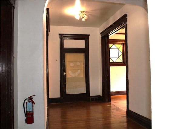 hallway with dark hardwood / wood-style floors