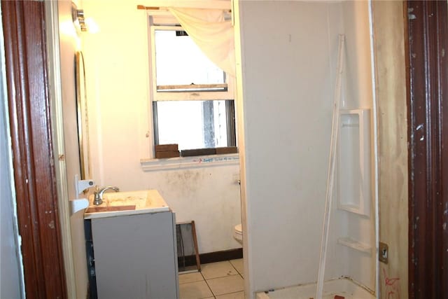 bathroom with tile patterned floors, vanity, toilet, and a shower