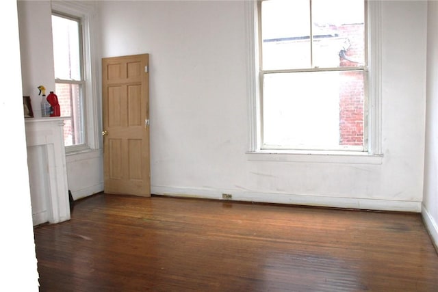 spare room featuring dark wood-type flooring