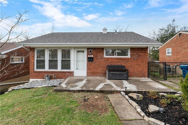 back of property featuring a lawn and a patio