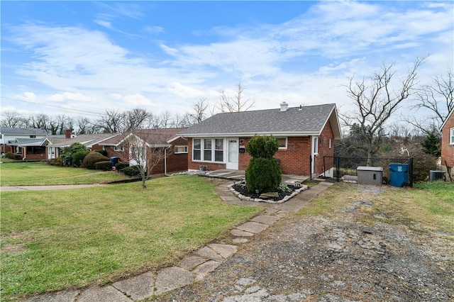 ranch-style home featuring a front yard and central AC