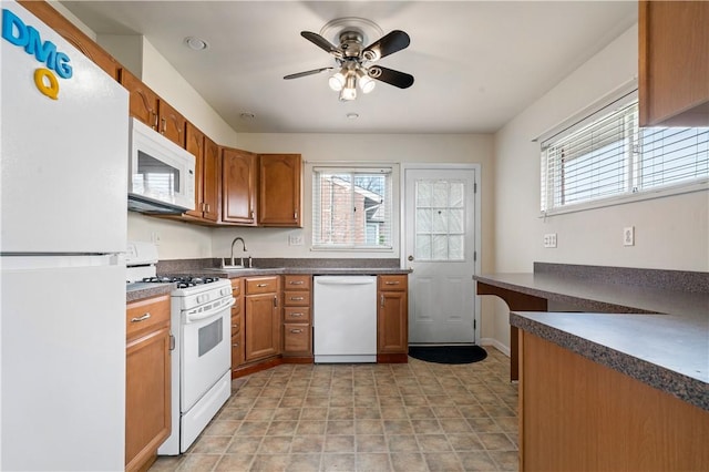 kitchen featuring white appliances, ceiling fan, and sink