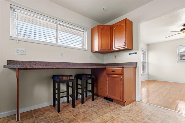 kitchen featuring ceiling fan and light hardwood / wood-style floors