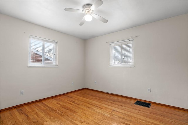 unfurnished room with ceiling fan, plenty of natural light, and light wood-type flooring