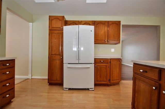 kitchen featuring white fridge and light hardwood / wood-style flooring