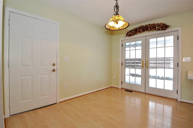 doorway to outside featuring light hardwood / wood-style flooring and french doors