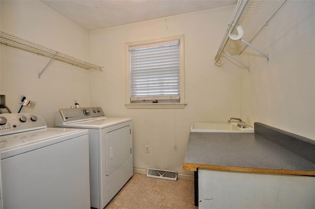 clothes washing area featuring washing machine and dryer and sink