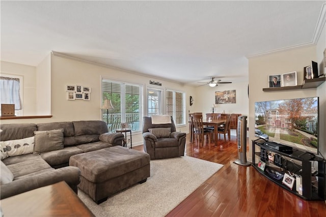 living room with hardwood / wood-style floors, ceiling fan, and crown molding