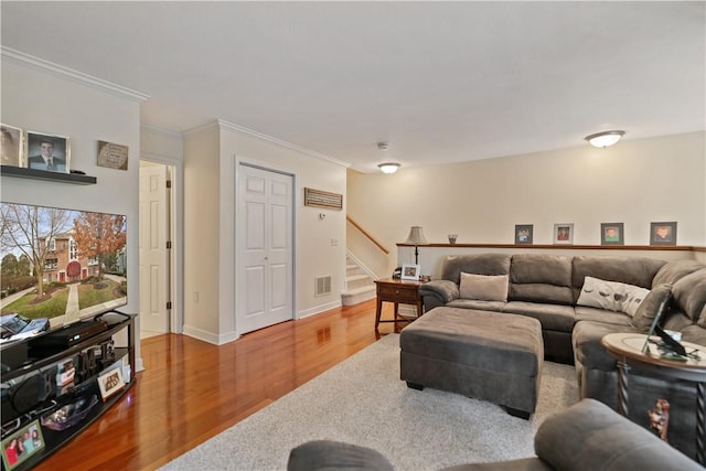 living room with wood-type flooring and crown molding