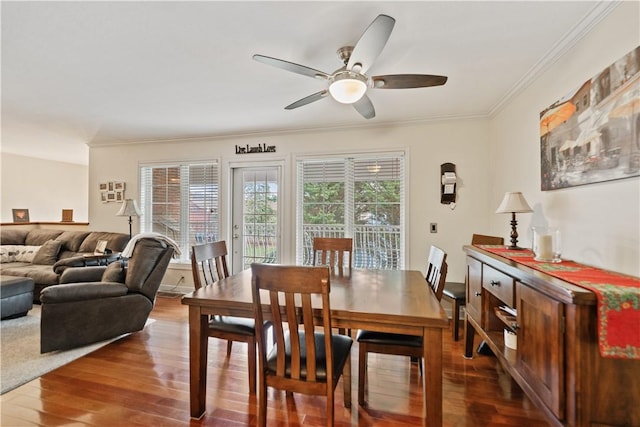 dining room featuring wood-type flooring, ceiling fan, and ornamental molding