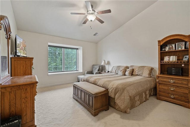 carpeted bedroom with ceiling fan and vaulted ceiling