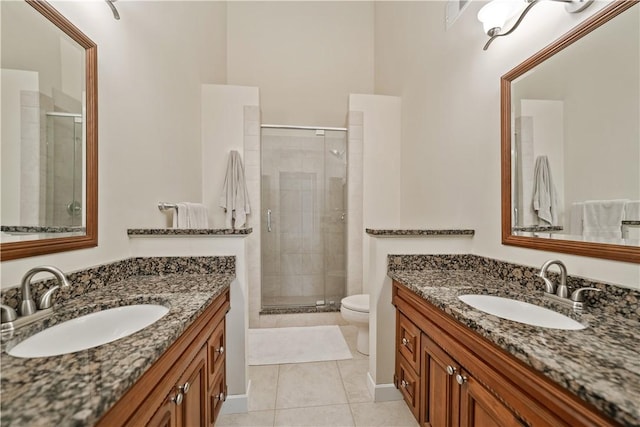 bathroom featuring tile patterned flooring, vanity, and an enclosed shower