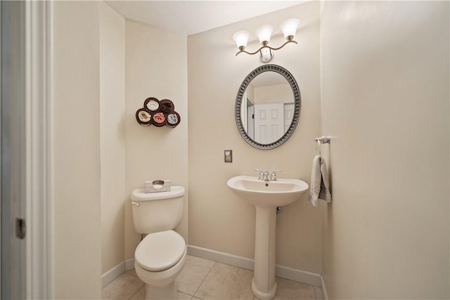 bathroom featuring tile patterned flooring, toilet, and sink