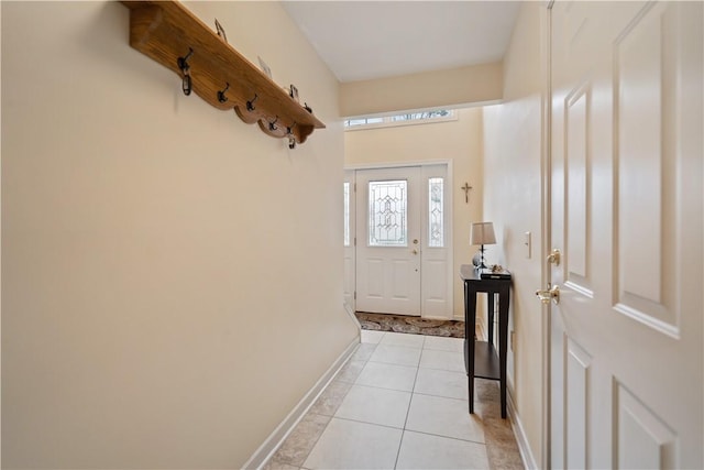 doorway to outside with light tile patterned flooring