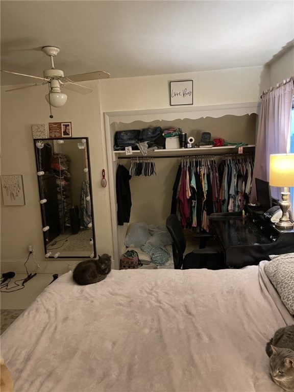 bedroom featuring ceiling fan and a closet