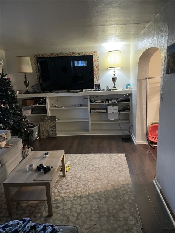 living room featuring dark wood-type flooring