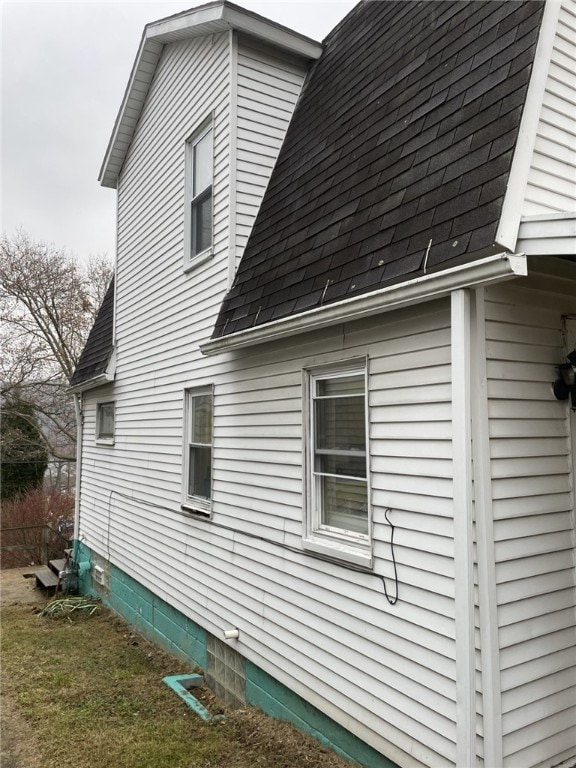 view of side of home with a lawn