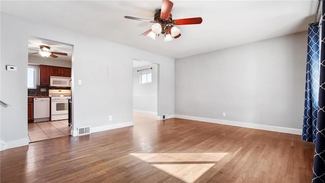 unfurnished living room featuring light hardwood / wood-style flooring and a healthy amount of sunlight