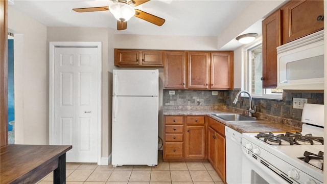 kitchen with white appliances, sink, ceiling fan, light tile patterned floors, and tasteful backsplash