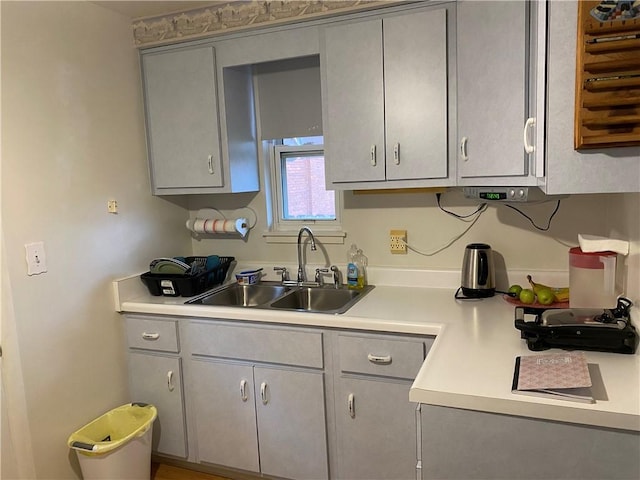 kitchen featuring gray cabinetry and sink