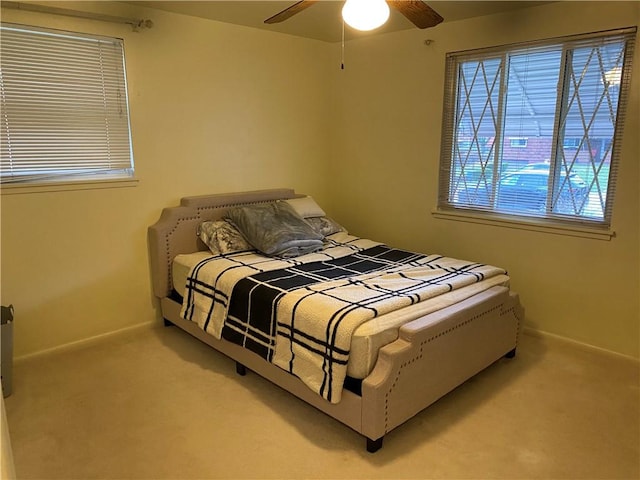 bedroom with ceiling fan and carpet floors