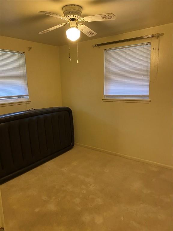 unfurnished bedroom with carpet flooring and ceiling fan