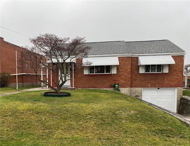 view of front of home with a front yard and a garage