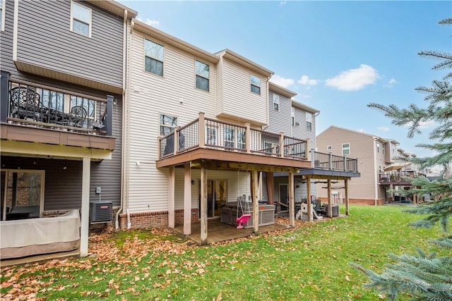 rear view of property featuring a yard, a patio, and central AC unit