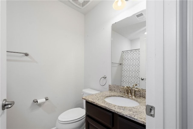 bathroom featuring vanity, curtained shower, and toilet