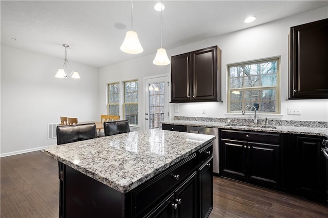 kitchen featuring a center island, dark wood-type flooring, plenty of natural light, and sink