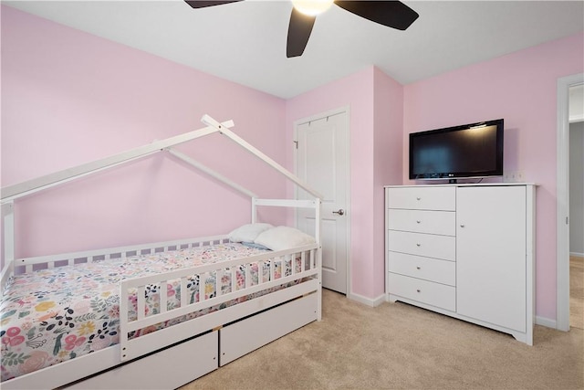 bedroom with ceiling fan and light carpet