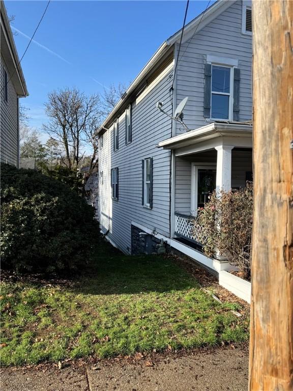 view of home's exterior with a lawn