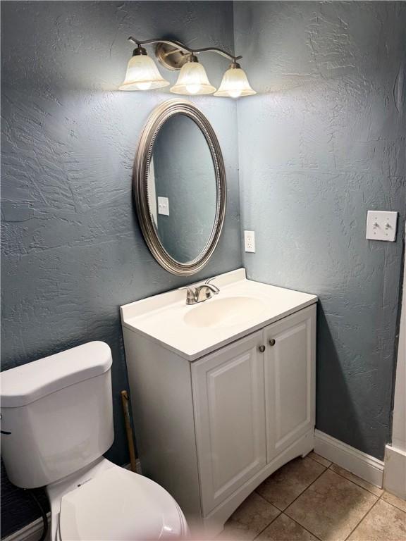 bathroom featuring toilet, vanity, and tile patterned floors