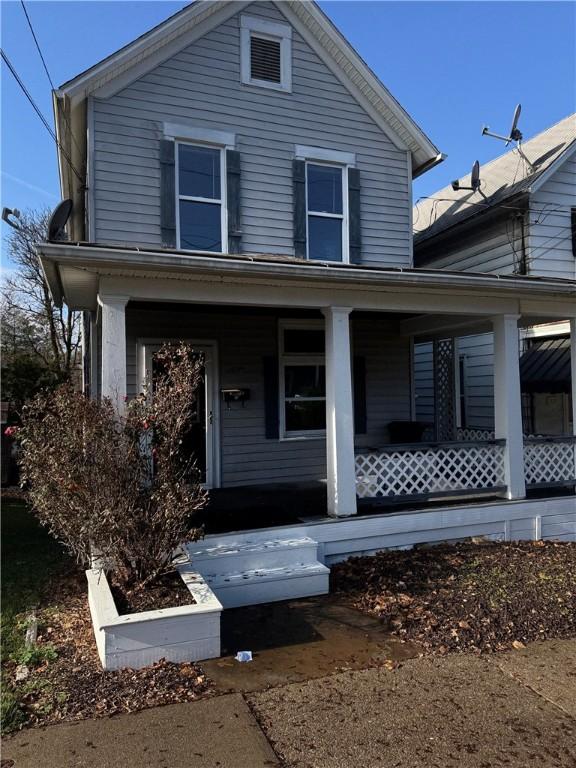 view of front property featuring covered porch