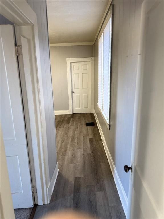 hall featuring dark hardwood / wood-style floors and ornamental molding