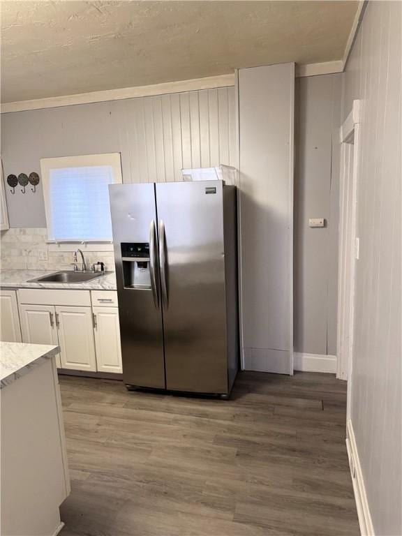 kitchen with backsplash, white cabinets, sink, stainless steel refrigerator with ice dispenser, and dark hardwood / wood-style floors