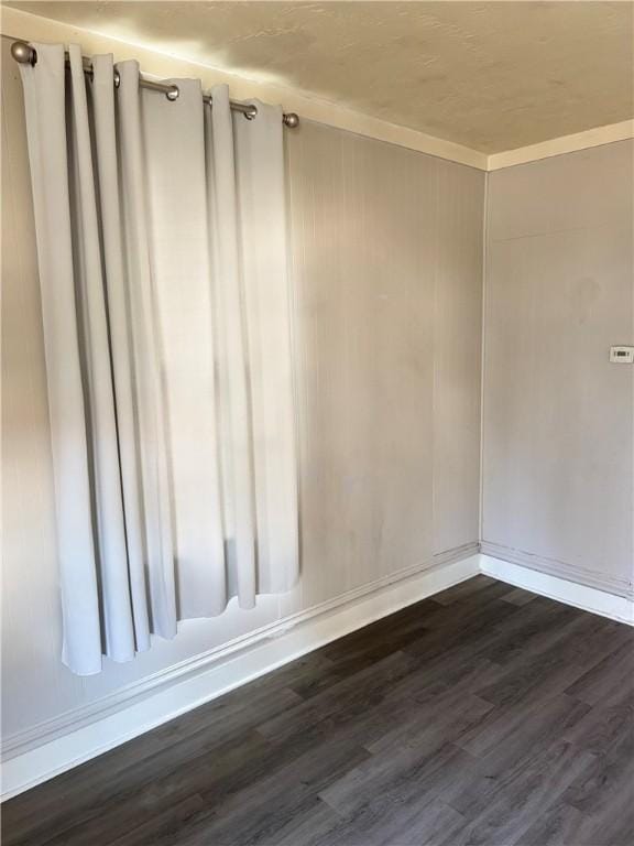 spare room featuring dark wood-type flooring