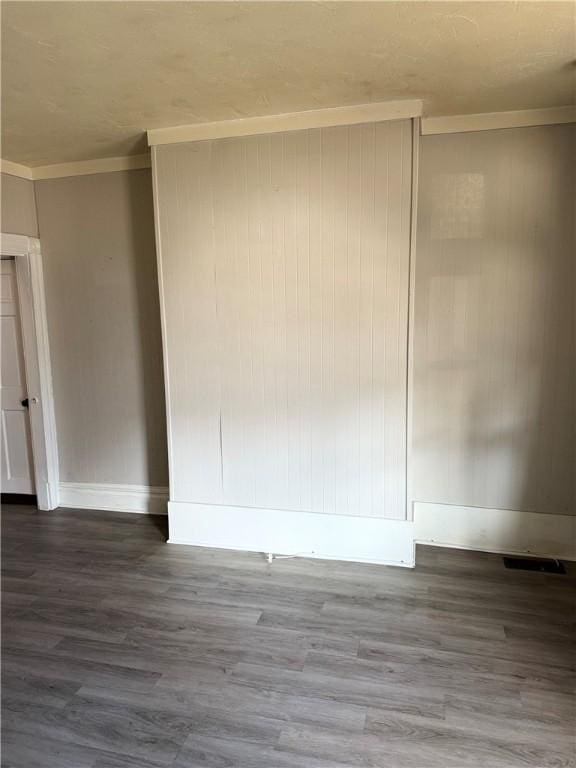 spare room with hardwood / wood-style flooring and ornamental molding