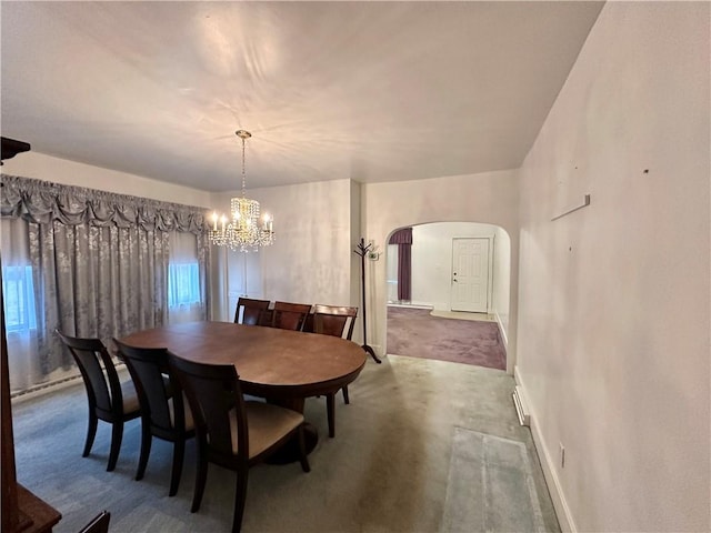 dining space with carpet floors, a baseboard radiator, and a notable chandelier