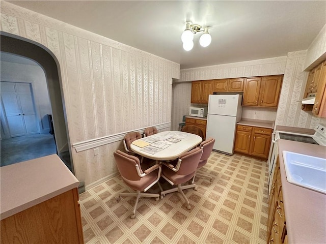 kitchen with sink and white appliances