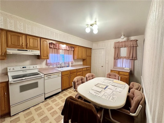 kitchen featuring white appliances and sink