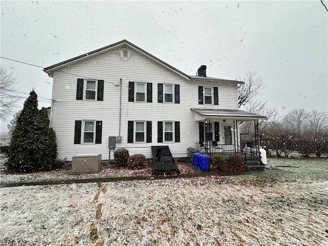 view of front facade featuring covered porch and cooling unit